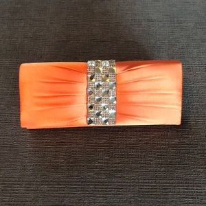Beautiful orange and rhinestone clutch.